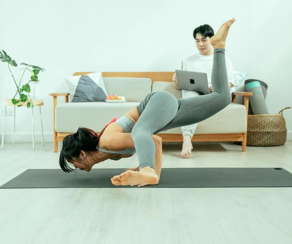 A calm and tidy space for home yoga practice with a mat and plant.